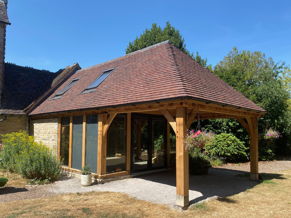 Oak framed garden room extension with porch by Shires Oak Buildings
